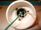 The resistor is installed down into the screw base.